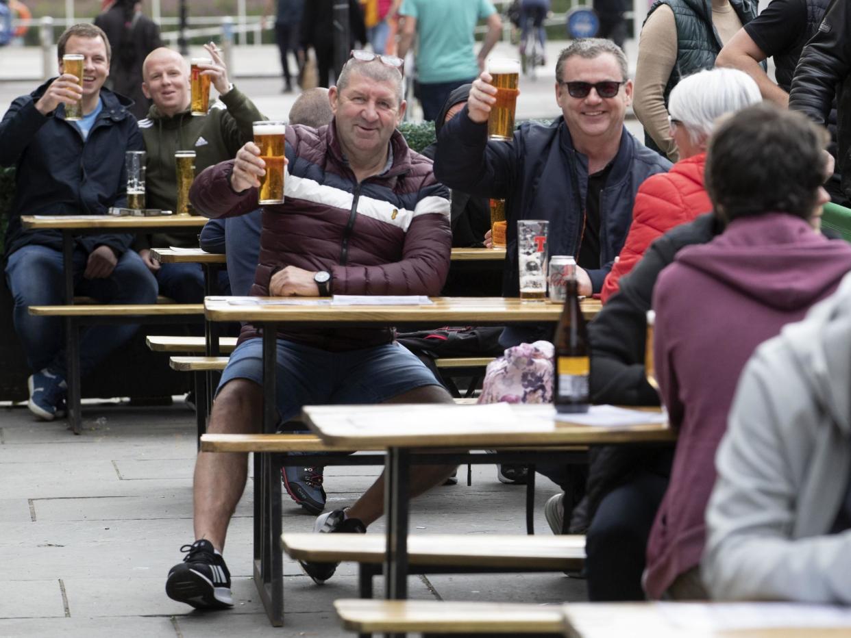 Members of the public enjoy their first drink in a beer garden at the Hootenanny, Glasgow: Jane Barlow/PA