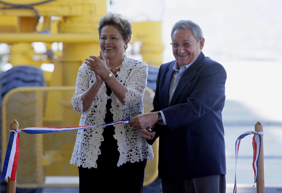 Brazil's President Dilma Rousseff, left, and Cuba's President Raul Castro cut the ribbonBrazil's President Dilma Rousseff, left, and Cuba's President Raul Castro make a tour by bus after the inauguration ceremony of the first phase of a port overhaul project in Mariel, Cuba, Monday, Jan. 27, 2014. The new port will be able to accommodate deeper-drafting "post-Panamax" ships that will begin crossing the Panama Canal once an expansion project there is completed in the next year or so.(AP Photo/Ismael Francisco, Cubadebate)