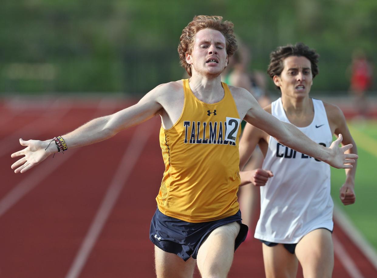 Tallmadge's Joseph Naiman celebrates crossing the finish line in front of Copley's Dylan Wood in the 1,600 meters during the Suburban League American Conference track championships at Tallmadge High School on Wednesday, May 8, 2024.