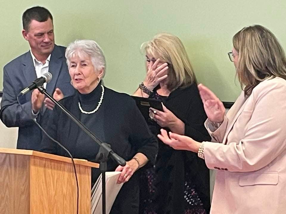 Griswold Senior Center Tina Falck (center), with Senior Center Building Committee Chair Rob Parrette (left), Committee Member Judith Merrill (at podium) and First Selectman Dana Bennett (right). Falck was recognized multiple times for her work for Griswold's seniors during the new Griswold Senior Community Wellness Center's grand opening.