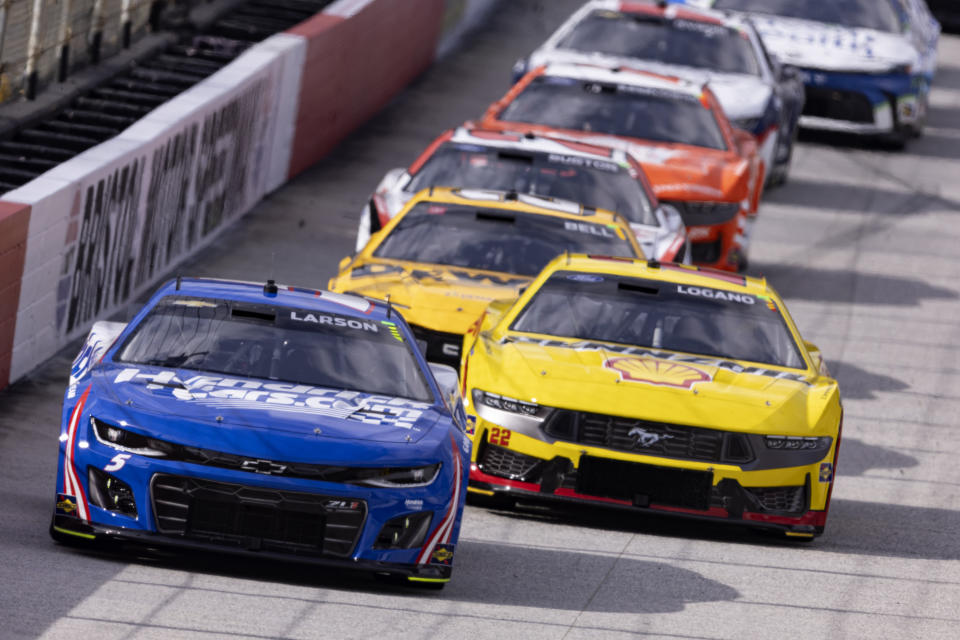 Kyle Larson (5) leads Joey Logano (22) and the field during a NASCAR Cup Series auto race, Sunday, March 17, 2024, in Bristol, Tenn. (AP Photo/Wade Payne)