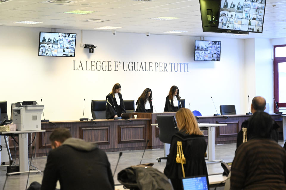 President of the court judge Brigida Cavasino, center, flanked by judges Claudia Caputo, left, and Germana Radice, reads the verdicts of a maxi-trial of hundreds of people accused of membership in Italy's 'ndrangheta organized crime syndicate, one of the world's most powerful, extensive and wealthy drug-trafficking groups, in Lamezia Terme, southern Italy, Monday, Nov. 20, 2023. Verdicts are expected Monday for the trial that started almost three years ago in the southern Calabria region, where the mob organization was originally based. (AP Photo/Valeria Ferraro)