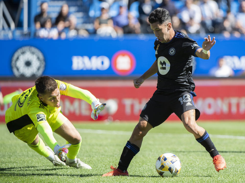 CF Montreal's Joaquin Torres, right, moves in on Chicago Fire FC goalkeeper Gabriel Slonina during first half MLS soccer action in Montreal, Sunday, Sept. 19, 2021. (Graham Hughes/The Canadian Press via AP)