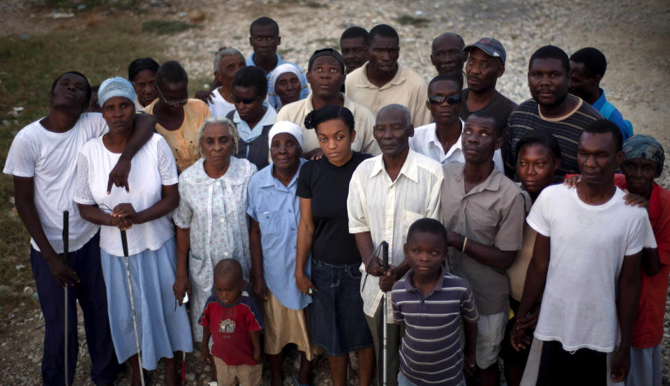 In this picture taken on Feb. 9, 2012, a group of blind people displaced by the 2010 earthquake pose for a photo at the La Piste camp in Port-au-Prince, Haiti. While more than a million people displaced by the 2010 quake ended up in post-apocalyptic-like tent cities, some of the homeless disabled population landed in the near-model community of La Piste, a settlement of plywood shelters along tidy gravel lanes. However, the rare respite for the estimated 500-plus people living at the camp is coming to an end as the government moves to reclaim the land. (AP Photo/Ramon Espinosa)