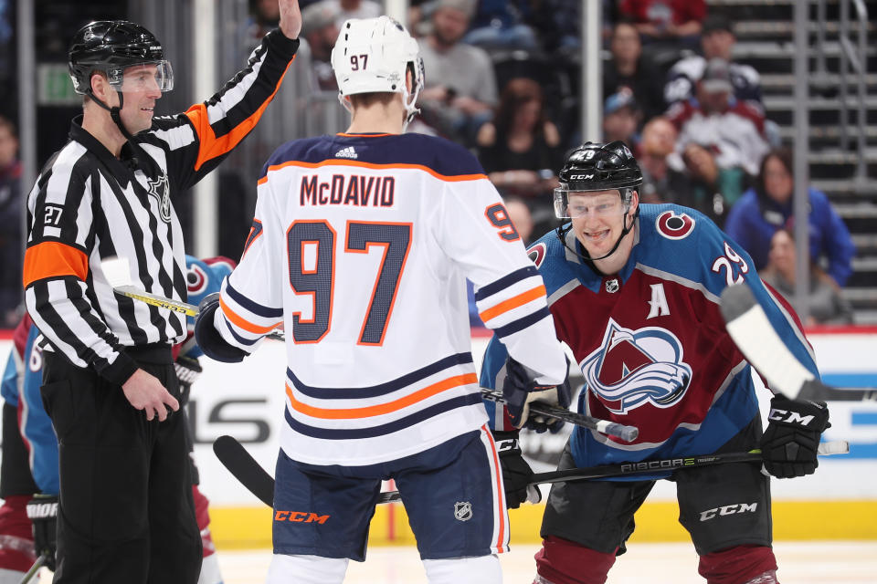 Nathan MacKinnon #29 of the Colorado Avalanche prepares for a face-off against Connor McDavid #97 of the Edmonton Oilers