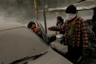 A family living near the errupting Taal Volcano evacuates in Lemery, Batangas City,