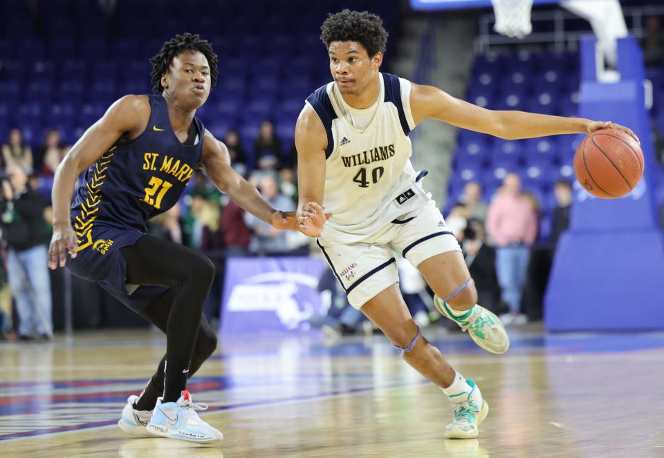 Archbishop Williams' Lorenzo Jackson dribbles past  St. Mary's Donel Kabongo during their MIAA Division 3 title game at the Tsongas Center in Lowell on Saturday, March 18, 2023.