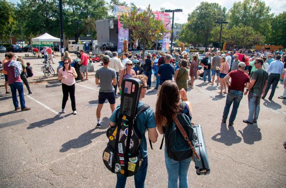 Bluegrass fans watch as the Chatham Rabbits perform outside the Duke Energy Center for the Performing Arts during the IBMA World of Bluegrass festival in downtown Raleigh Friday, Oct. 1, 2021.