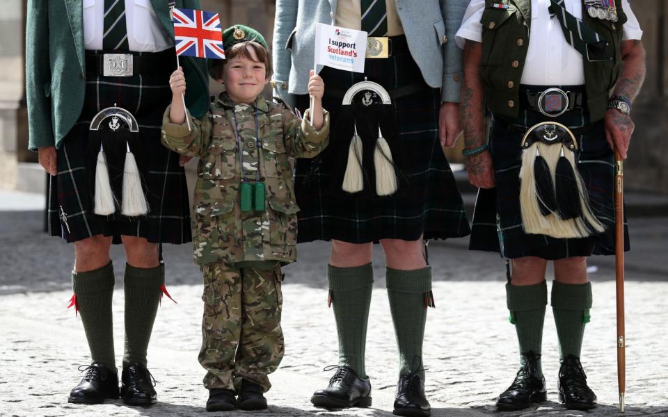 Six-year-old Luca Gordon from Edinburgh with ex-service personnel from Legion Scotland - Credit: Andrew Milligan/PA