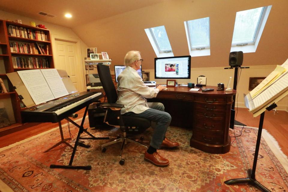 Composer Richard Sortomme works at the computer in his home studio.