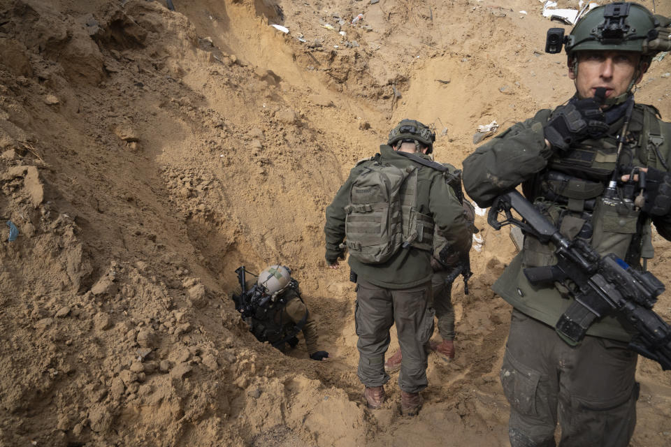 Israeli soldiers enter a Hamas tunnel underneath a cemetery during the ground offensive on the Gaza Strip in Khan Younis, Saturday, Jan. 27, 2024. (AP Photo/Sam McNeil)