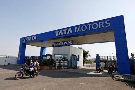 Men ride a motorbike as they come out of a past a Tata Motors car plant at Sanand in Gujarat, India, October 27, 2016. REUTERS/Amit Dave