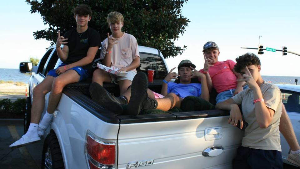 Trey Barnerd (far left) and friends pose in the back of his squatted Ford F-150.