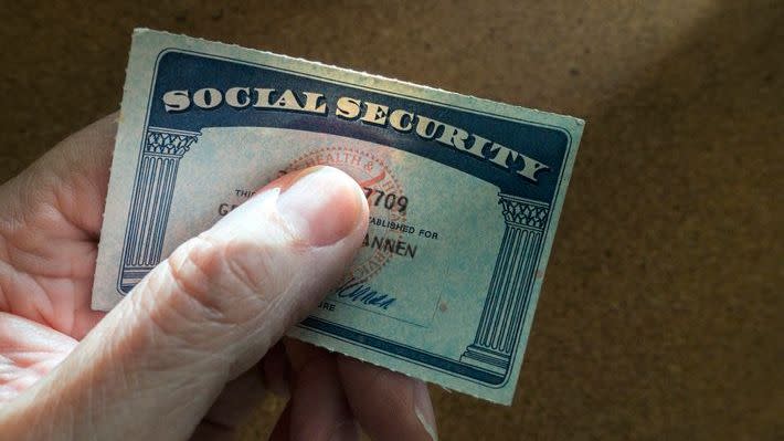 A senior citizen holds their Social Security. 