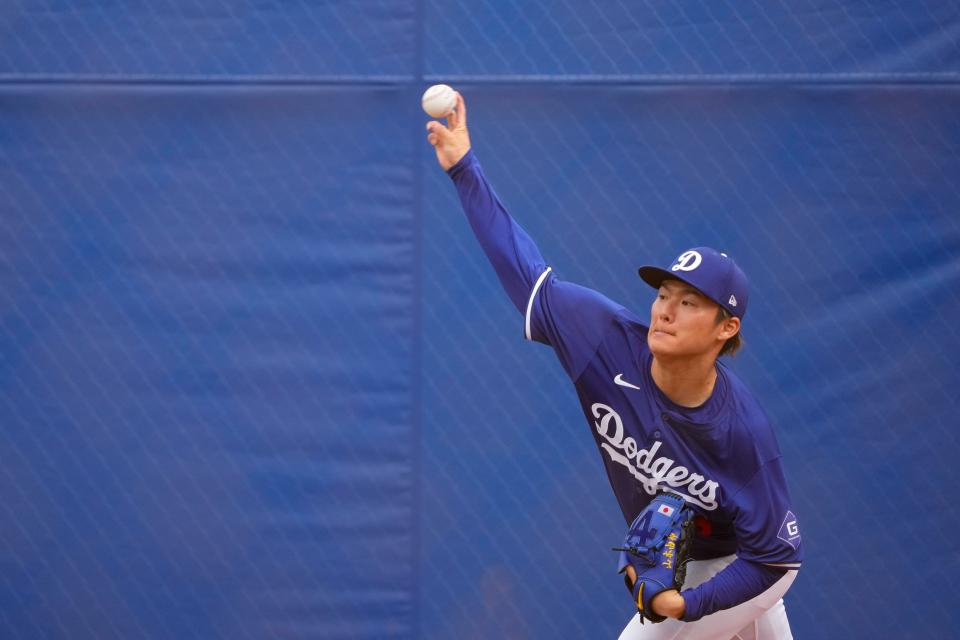 Los Angeles Dodgers pitcher Yoshinobu Yamamoto throws a bullpen session during spring training baseball workouts Monday, Feb. 26, 2024, in Phoenix. (AP Photo/Lindsey Wasson)