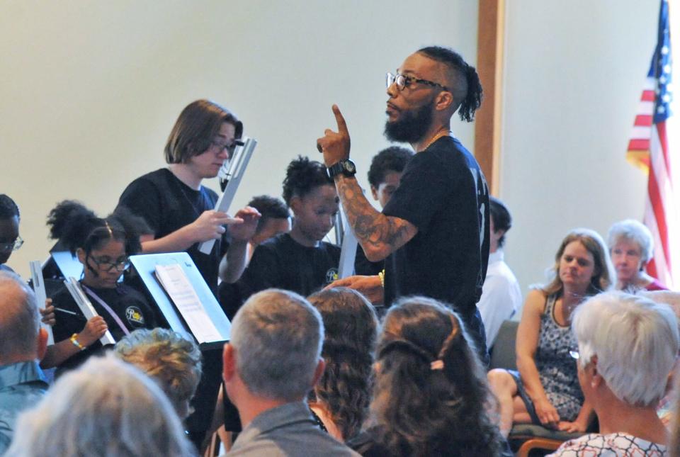 Greg Fernandes directs his students from the Rose Conservatory of Brockton during the "Spring Ring" hand bell concert at the United Church of Christ in Norwell, Sunday, June 12, 2022.