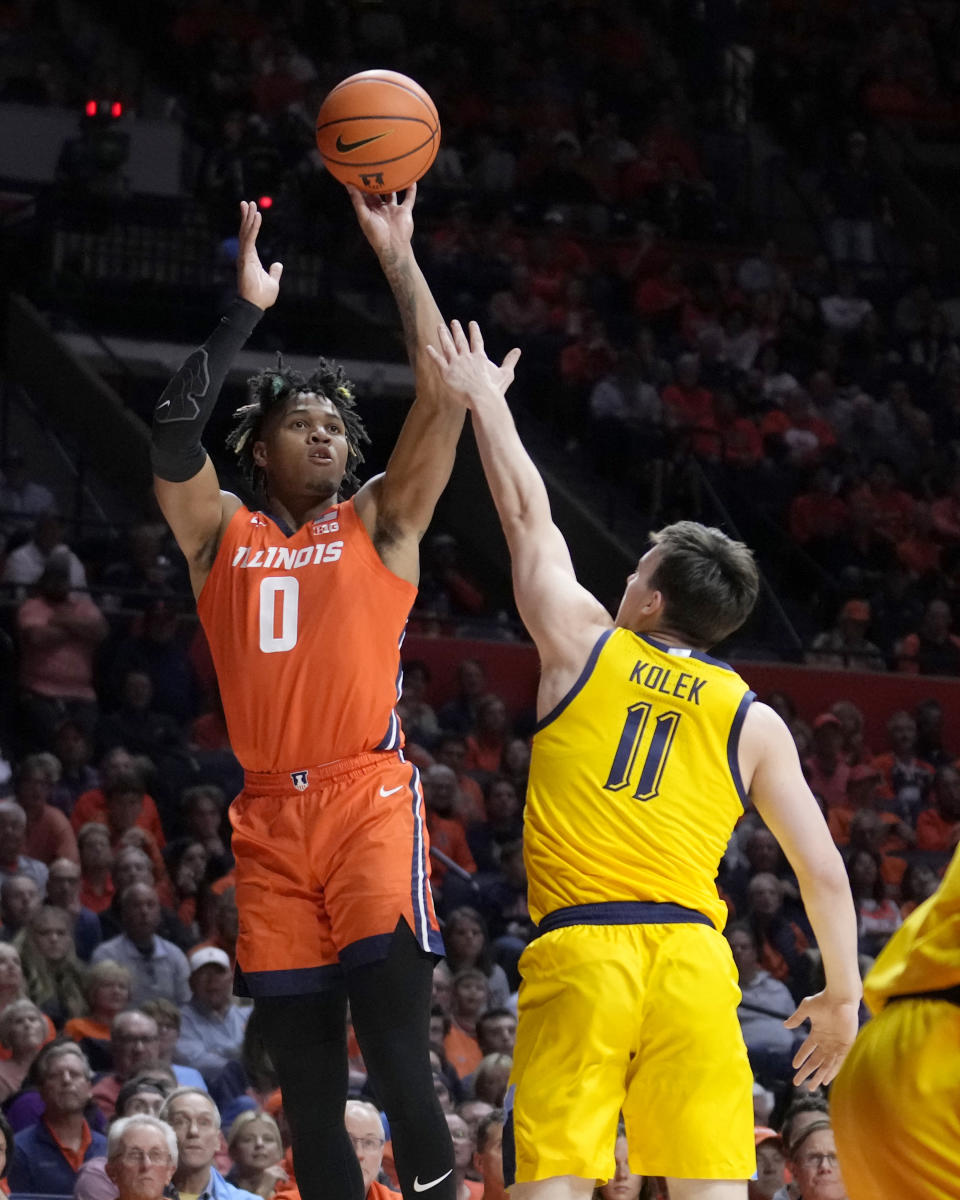 Illinois' Terrence Shannon Jr. (0) shoots over Marquette's Tyler Kolek during the first half of an NCAA college basketball game Tuesday, Nov. 14, 2023, in Champaign, Ill. (AP Photo/Charles Rex Arbogast)