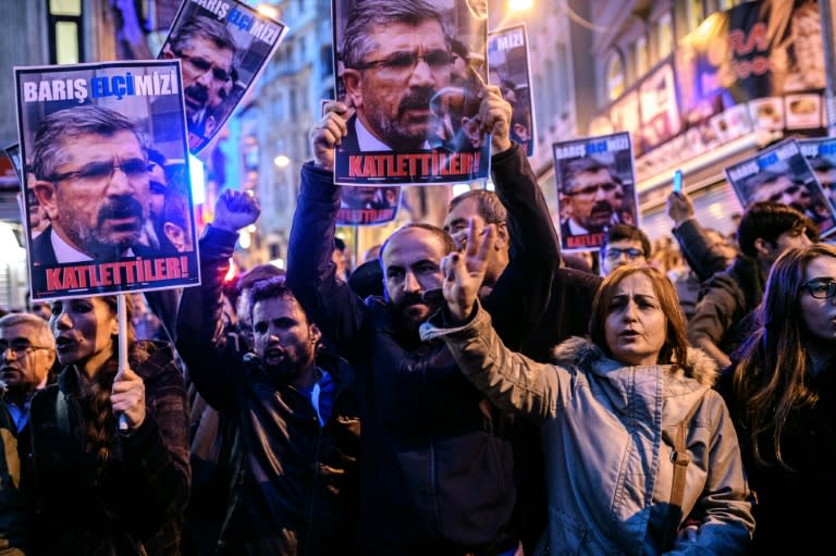 Protesters hold pictures of Kurdish lawyer Tahir Elci reading "They slaughtered him!" during a demonstration in Istanbul after he was killed in Diyarbarkir on November 28, 2015