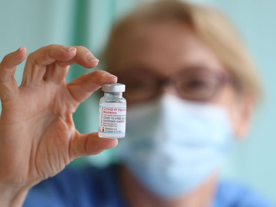 Nurse Lisa Kieh holds a vial of the Moderna Covid-19 vaccine at a vaccination centre at Ffwrnes Theatre in Llanelli, South Wales (AFP via Getty Images)