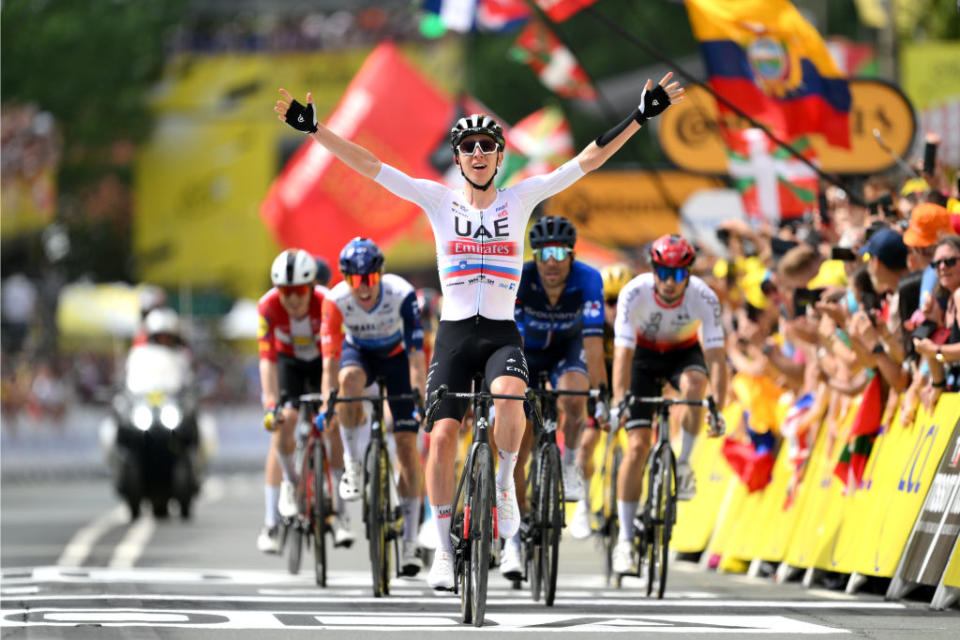 BILBAO SPAIN  JULY 01 Tadej Pogacar of Slovenia and UAE Team Emirates crosses the finish line as third place and celebrates the victory of his teammate Adam Yates of United Kingdom and UAE Team Emirates during the stage one of the 110th Tour de France 2023 a 182km stage from Bilbao to Bilbao  UCIWT  on July 01 2023 in Bilbao Spain Photo by David RamosGetty Images