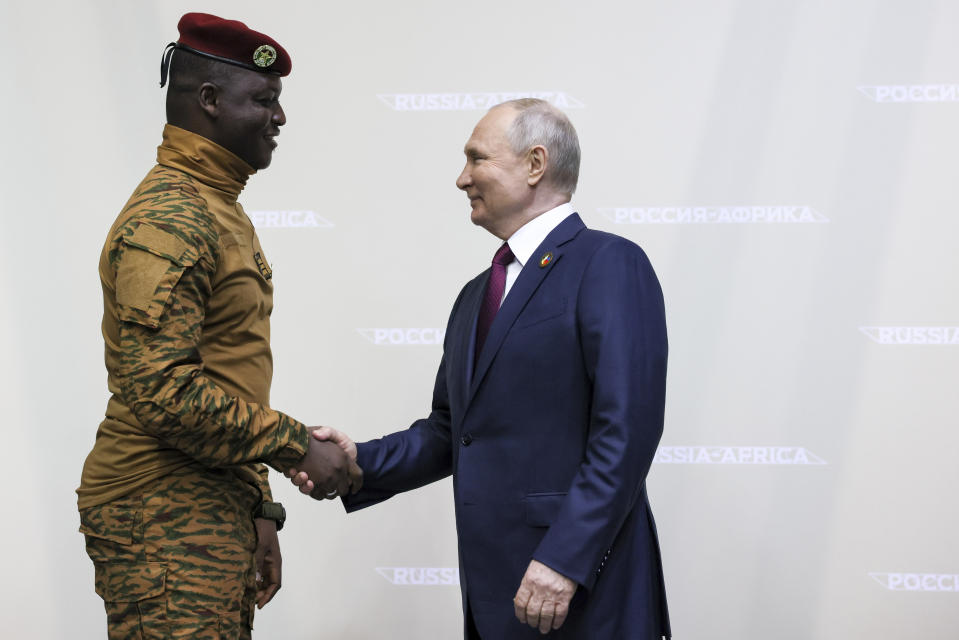 Russian President Vladimir Putin, right, and the President of the Transition period of Burkina Faso, Head of State Ibrahim Traore, shake hands on the sideline of the Russia Africa Summit in St. Petersburg, Russia, Thursday, July 27, 2023. (Mikhail Metzel/TASS Host Photo Agency Pool Photo via AP)