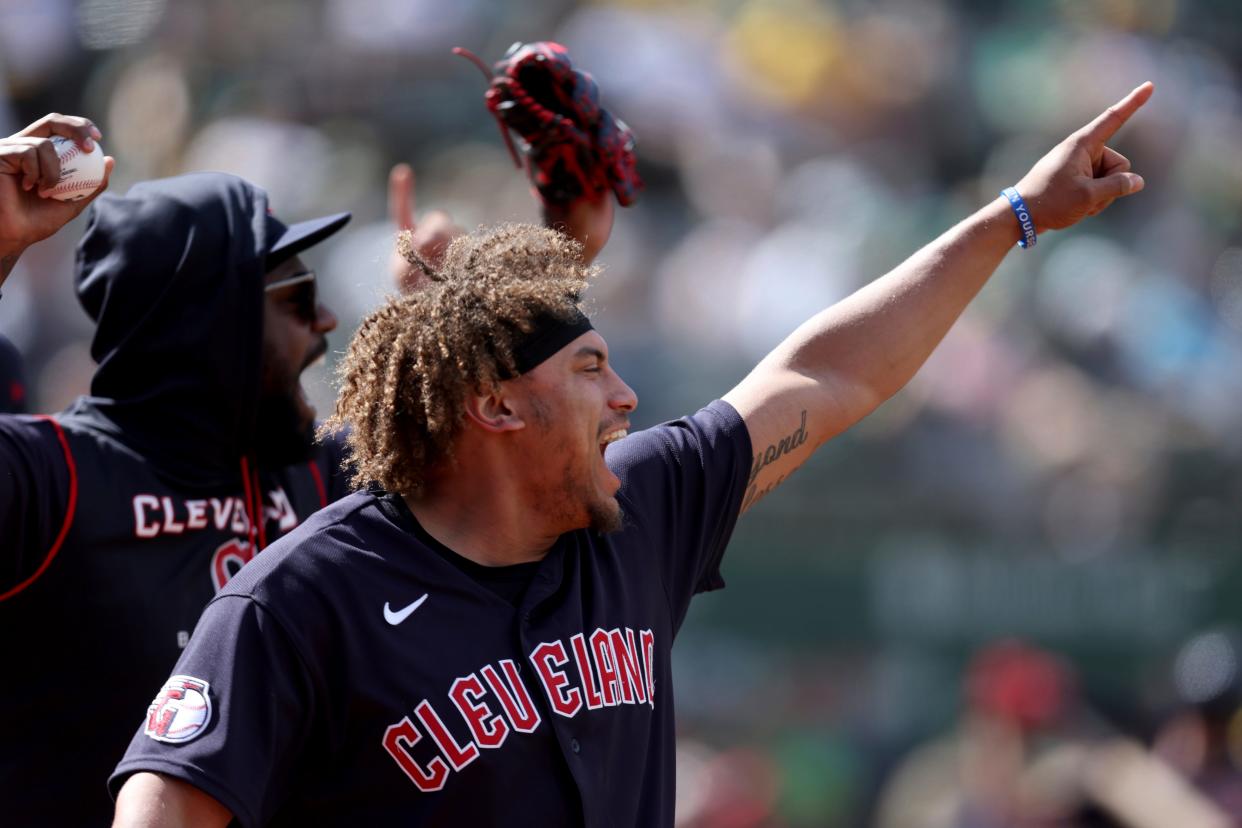 Cleveland Guardians' Josh Naylor, foreground, reacts after a double hit by Richie Palacios against the Oakland Athletics during the ninth inning of a baseball game in Oakland, Calif., Saturday, April 30, 2022. (AP Photo/Jed Jacobsohn)