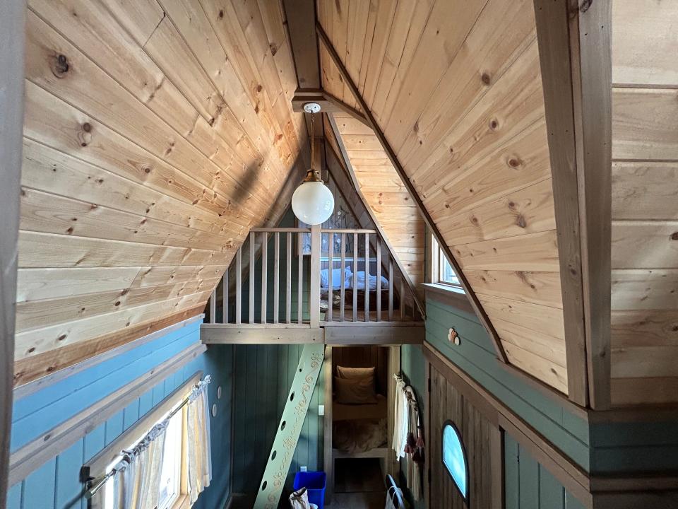 slanted wood ceilings and circle lamp  in Rapunzel's Cottage