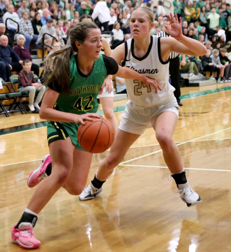 Northridge's Lily Scholl (42) drives on Penn’s Anna McCullough (24) during the Northridge vs. Penn girls sectional basketball championship game Saturday, Feb. 3, 2024, at Northridge Middle School.