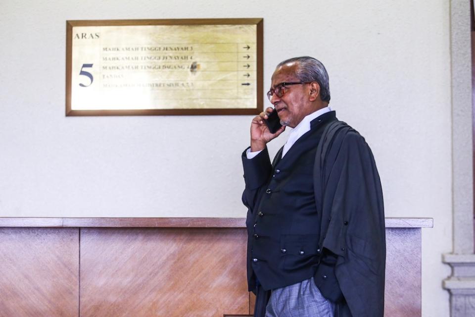 Tan Sri Muhammad Shafee Abdullah makes a call at the Kuala Lumpur Courts Complex August 19, 2019. — Picture by Hari Anggara