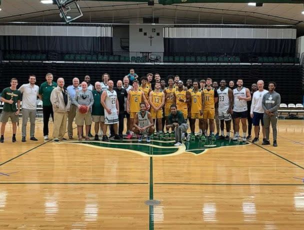 PHOTO: Aiden Webster, the son of Saint Leo University assistant basketball coach Ashley Webster, is pictured alongside the university's men's basketball team. (Pam Randall)