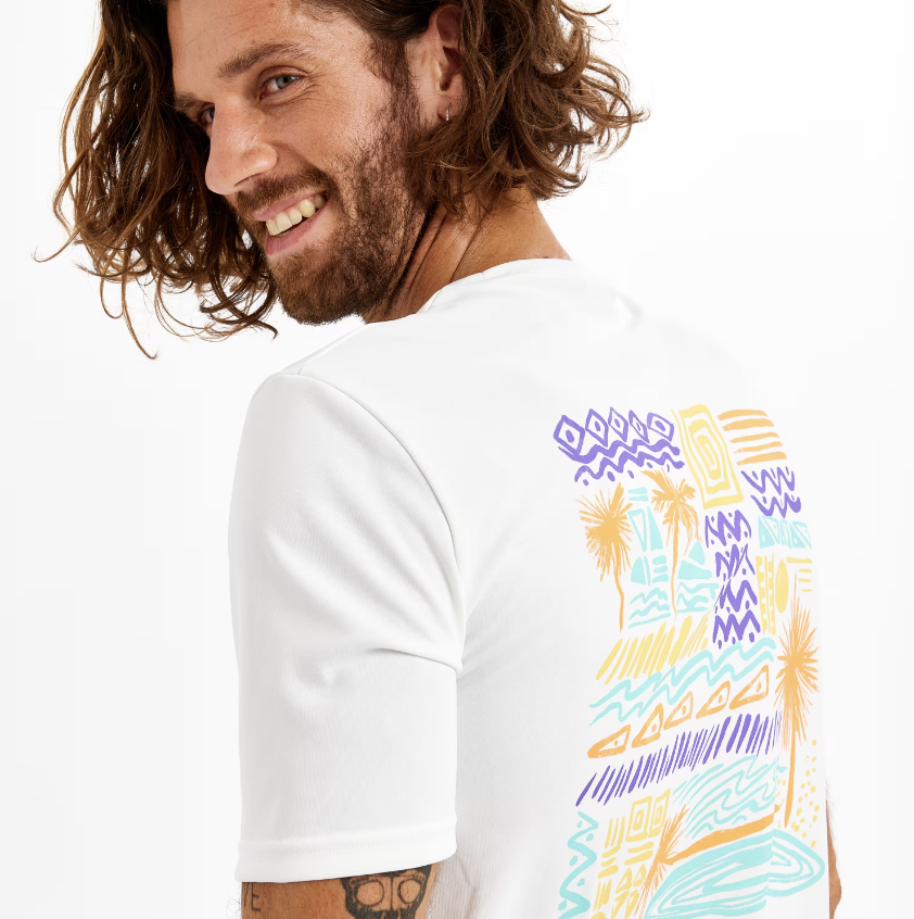 A photo of a model wearing a Men's Surfing Short-Sleeved Anti-UV T-Shirt - Palm white. (PHOTO: Decathlon Singapore)