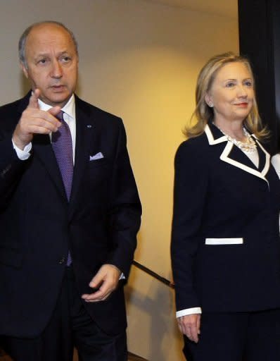 US Secretary of State Hillary Clinton and French Foreign Minister Laurent Fabius arrive for the "Friends of the Syrian People" conference in Paris. International leaders Friday urged the UN to ratchet up pressure on Syrian President Bashar al-Assad by threatening his regime with tough sanctions, as the defection of a top general rocked his inner circle