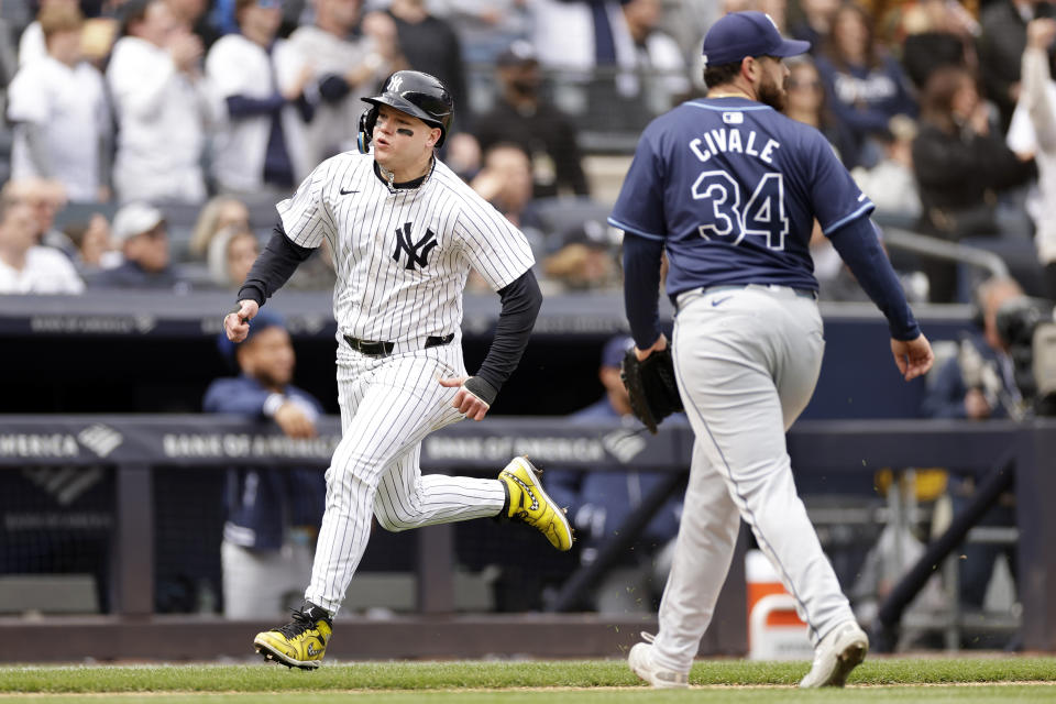 New York Yankees' Alex Verdugo, left, comes around to score past Tampa Bay Rays pitcher Aaron Civale (34) during the fifth inning of a baseball game Sunday, April 21, 2024, in New York. (AP Photo/Adam Hunger)