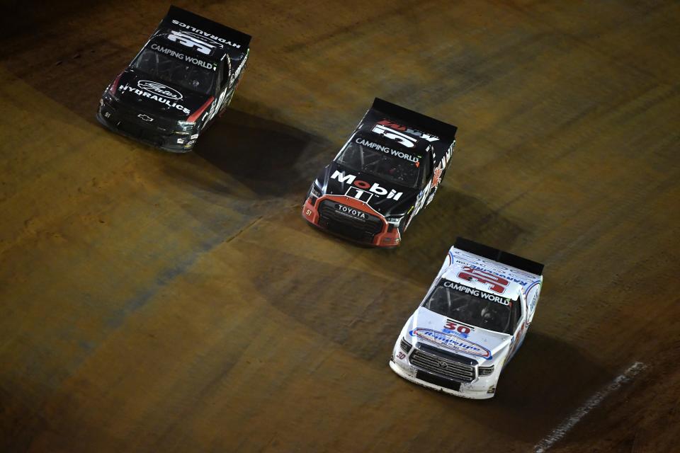 BRISTOL, TENNESSEE - APRIL 16: Colby Howard, driver of the #91 Gates Hydraulics Chevrolet, Buddy Kofoid, driver of the #51 Mobil 1 Toyota, and Tate Fogleman, driver of the #30 Rangeline Group Toyota, race during the NASCAR Camping World Truck Series Pinty\