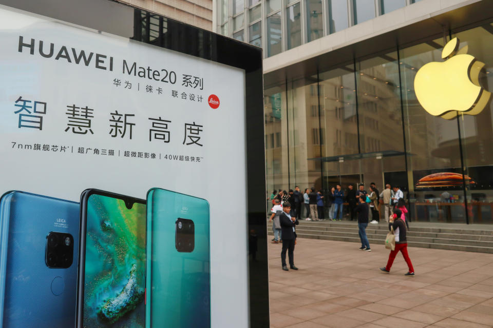 An ad for Huawei in front of an Apple store in Shanghai. (Photo: Reuters)