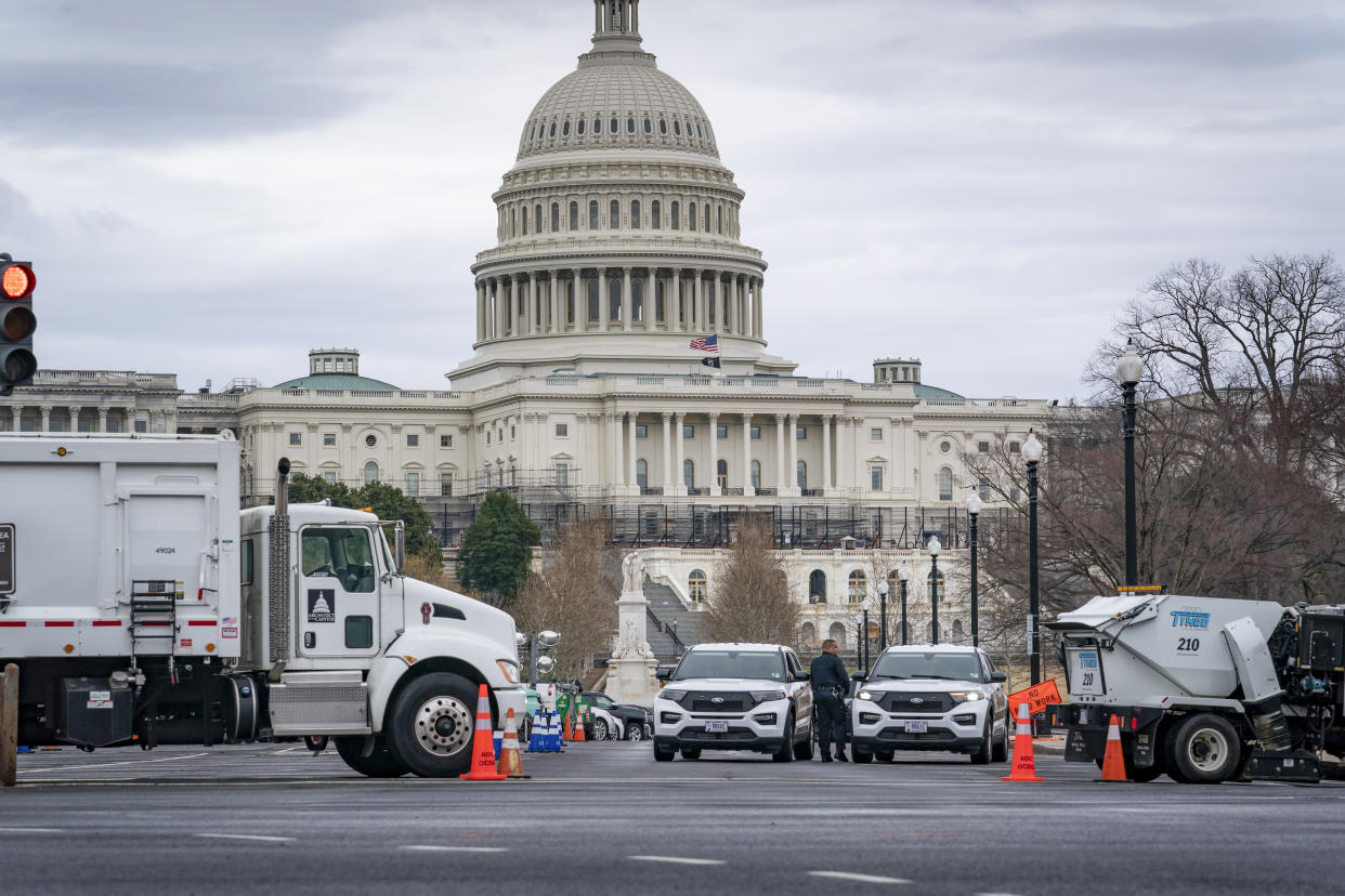 Heavy vehicles, including garbage trucks and snow plows, are set near the entrance to Capitol Hill at Pennsylvania Avenue and 3rd Street NW in Washington, Tuesday, Feb. 22, 2022, amid reports that trucker protests will arrive on March 1, the day of President  Biden's State of the Union address. (AP Photo/J. Scott Applewhite)