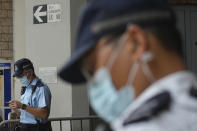 Police officers stand guard as they wait for Tong Ying-kit's arrival at the Hong Kong High Court in Hong Kong Friday, July 30, 2021. Tong Ying-kit was convicted Tuesday of inciting secession and terrorism for driving his motorcycle into a group of police officers during a July 1, 2020, pro-democracy rally while carrying a flag bearing the banned slogan, "Liberate Hong Kong, revolution of our times." Tong, 24, will be sentenced Friday, the court announced. (AP Photo/Vincent Yu)
