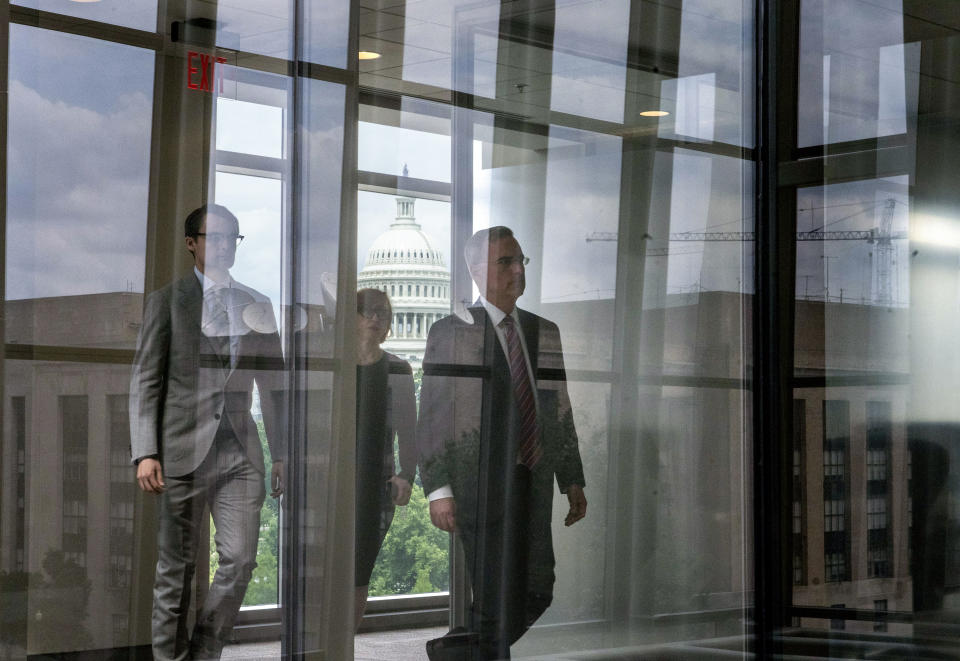 Pat Cipollone, right, the former White House counsel under President Donald Trump, walks to a conference room for a break from an interview room in the Ford House Office Building while answering questions from investigators with the Jan. 6 Select Committee, on Capitol Hill in Washington, Friday, July 8, 2022. The U.S. Capitol is seen behind. (AP Photo/Gemunu Amarasinghe)