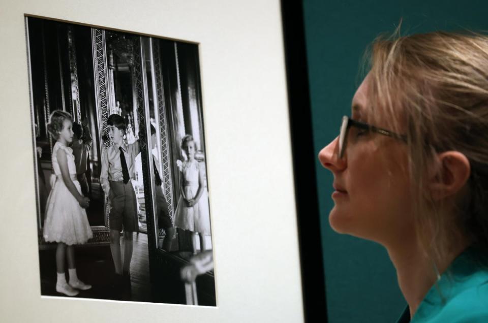 A gallery worker views a photograph of Princess Anne and Prince Charles by Anthony Armstrong-Jones (EPA)