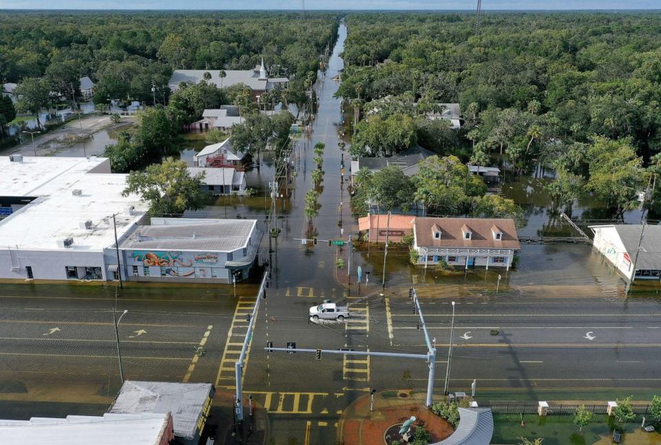 PHOTO: A vehicle drives through a flooded street in the downtown area after Hurricane Idalia passed offshore on Aug. 30, 2023, in Crystal River, Fla. Hurricane Idalia hit the Big Bend area on the Gulf Coast of Florida as a Category 3 storm. (Joe Raedle/Getty Images)