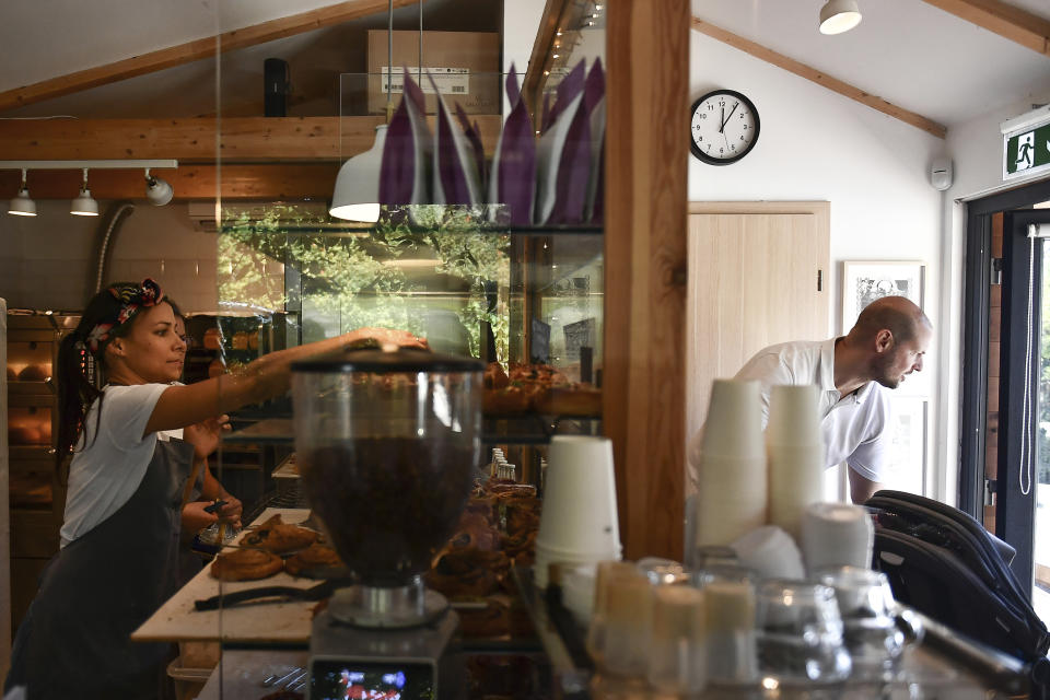 Eszter Roboz, bakery owner, prepares some pastries in Babushka Artisanal Bakery in Budapest, Hungary, Friday, Sept. 9, 2022. The gourmet bakery has raised its prices by 10% to keep up with rapidly rising costs of energy and raw materials, and taken steps to moderate its use of electricity to avoid having to close down. (AP Photo/Anna Szilagyi)