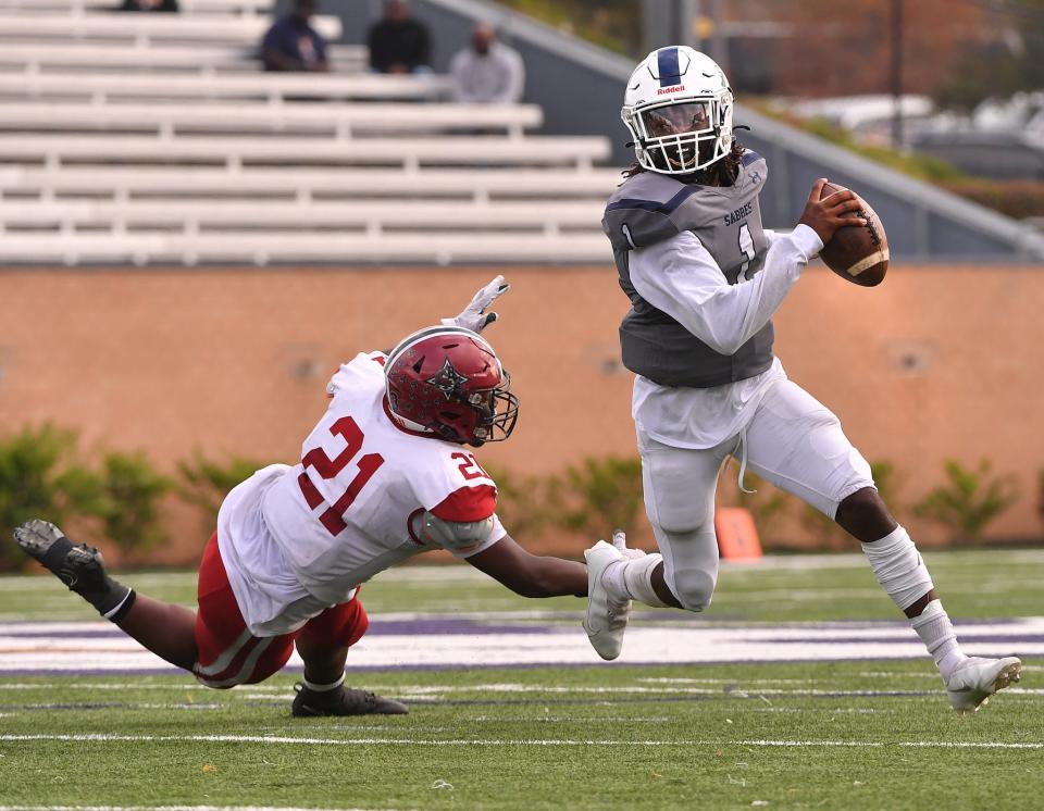 The Southside Christian Sabres take on the Bamberg-Ehrhardt Red Raiders in the SCHSL 1A State Championship football game, held at Benedict College in Columbia, Saturday evening, December 4, 2021. Southside Christian quarterback Ja'Corey Martin (1) runs the ball against defense from Bamberg-Ehrhardt.