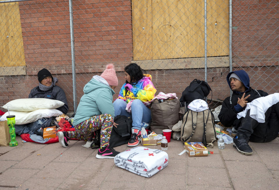 A migrant family from Venezuela camps on a street in downtown El Paso, Texas, Sunday, Dec. 18, 2022. Texas border cities were preparing Sunday for a surge of as many as 5,000 new migrants a day across the U.S.-Mexico border as pandemic-era immigration restrictions expire this week, setting in motion plans for providing emergency housing, food and other essentials. (AP Photo/Andres Leighton)