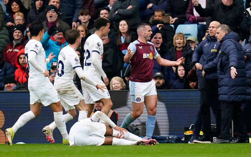 Aston Villa's John McGinn (centre) is confronted by Tottenham Hotspur players after his challenge on Tottenham Hotspur's Destiny Udogie