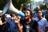 A demonstrator yells into a megaphone outside the football stadium as the NFL's Carolina Panthers host the Minnesota Vikings protesting of the police shooting of Keith Scott in Charlotte, North Carolina, U.S., September 25, 2016. REUTERS/Mike Blake