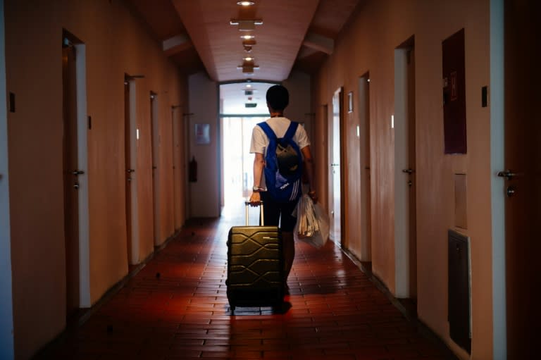 A tourist walks through a hallway on the way to a room at the hostel 'Celica' in Ljubljana, Slovenia