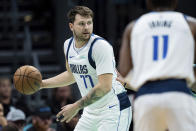 Dallas Mavericks guard Luka Doncic (77) looks to pass during the first half of an NBA basketball game against the Charlotte Hornets Tuesday, April 9, 2024, in Charlotte, N.C. (AP Photo/Jacob Kupferman)