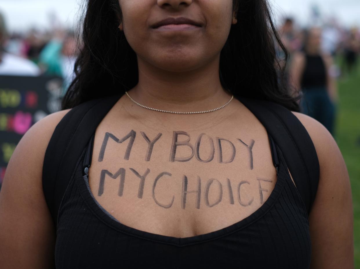 An abortion rights demonstrator has the words My Body My Choice written on her front as she gathers near the Washington Monument during a nationwide rally in support of abortion rights in Washington, D.C.