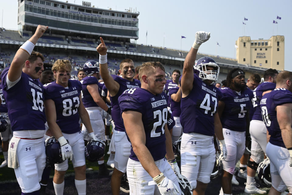 Northwestern players celebrate after an NCAA college football game against Indiana State in Evanston, Ill., Saturday, Sept. 11, 2021. (AP Photo/Matt Marton)