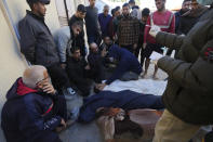 Palestinians mourn relatives killed in the Israeli bombardments of the Gaza Strip at Al Aqsa Hospital in Deir al Balah, Gaza Strip, on Friday, March 8, 2024. (AP Photo/Adel Hana)